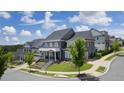 Two story gray house with white accents, and a metal roof in a neighborhood at 3065 Barnes Mill Ct, Roswell, GA 30075