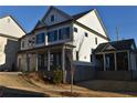 Two-story home with white siding, dark shutters, and a detached garage at 3065 Barnes Mill Ct, Roswell, GA 30075