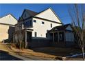 Two-story house with white siding, gray roof, and a covered porch at 3065 Barnes Mill Ct, Roswell, GA 30075