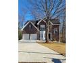 Brick house with two-car garage and landscaped yard at 700 Somerset Vale Dr, Lawrenceville, GA 30044