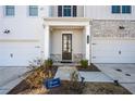 Townhome front entrance with stone accents, double doors and landscaping at 1706 Pardee Dr, Kennesaw, GA 30152