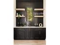 Elegant wet bar with dark cabinetry, floating shelves, and a quartz countertop at 6055 Tattnall Overlook, Acworth, GA 30101