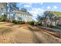 Landscaped yard with a two-story light blue house at 718 Creek Nw Trl, Kennesaw, GA 30144