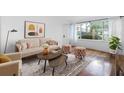 Bright living room featuring stylish furnishings, hardwood floors, and large windows offering a pleasant view at 2240 Cheshire Bridge Rd # 205, Atlanta, GA 30324