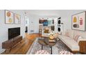 Inviting living room showcasing hardwood floors, contemporary decor, and seamless flow into the kitchen at 2240 Cheshire Bridge Rd # 205, Atlanta, GA 30324