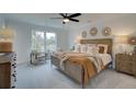 Spacious main bedroom with large windows, plush bedding, and stylish furniture at 417 Carrera Ln, Acworth, GA 30102