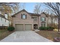 Brick two-story house with a two-car garage and landscaped yard at 437 Cherry Tree Ln, Marietta, GA 30066