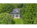 Beautiful home with lush green lawn, mature trees, manicured landscaping, and charming double staircase entry at 117 N Cove Dr, Peachtree City, GA 30269