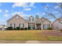 Brick home with a large front yard and beautiful landscaping at 3210 Sand Hill Ct, Cumming, GA 30041