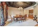 Formal dining room with a large table and decorative ceiling at 630 Birnamwood Dr, Suwanee, GA 30024
