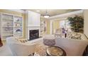 Spacious living room with built-in shelving and a fireplace at 630 Birnamwood Dr, Suwanee, GA 30024