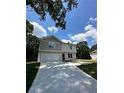 Two-story house with gray and beige siding, a red door, and a two-car garage at 1331 E Atlanta E Rd, Stockbridge, GA 30281