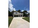 Two-story house with green door and attached garage at 1341 E Atlanta E Rd, Stockbridge, GA 30281