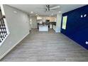 Open concept living room features gray LVT flooring and a blue accent wall at 1351 E Atlanta E Rd, Stockbridge, GA 30281