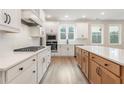 Bright kitchen with white cabinets, quartz countertops, and a gas cooktop at 2719 Byess Ct, Marietta, GA 30064