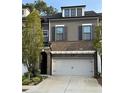 Attractive two-story home boasts a brick facade, grey siding, and a two-car garage at 290 Walker Ave, Alpharetta, GA 30076