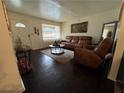 Inviting living room with dark wood floors, neutral rug and modern furniture at 987 Forrest Se Cir, Atlanta, GA 30354