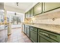 Kitchen with green cabinets, granite counters, and breakfast nook at 2015 Huntingdon, Atlanta, GA 30350