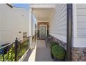 Front porch with gray door, stone accents, and two black chairs at 3948 Lake Manor Way, Atlanta, GA 30349