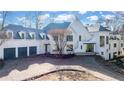 Impressive white home with gray roof and a three car garage at 1890 W Paces Ferry Nw Rd, Atlanta, GA 30327