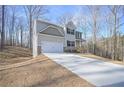 Two-story house with light beige siding, stone accents, and a driveway at 509 Ajo Way, Dallas, GA 30157