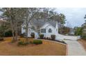 Two story house with white siding, landscaping, and a long driveway at 8255 Stonebrook Dr, Cumming, GA 30040