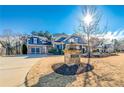 Elegant home with a stone address marker, attached garage, and mature trees on a manicured lawn at 4960 Shade Creek Xing, Cumming, GA 30028