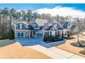 Stately two-story home featuring a symmetrical facade, gabled roof, and manicured landscaping at 4960 Shade Creek Xing, Cumming, GA 30028