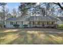 Gray house with wooden front porch at 7270 Oswego Trl, Riverdale, GA 30296