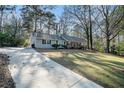 Ranch style home with a large yard and driveway at 7270 Oswego Trl, Riverdale, GA 30296