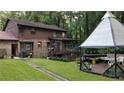 Home's backyard with a gazebo and patio at 4567 Town Crier Sw Rd, Lilburn, GA 30047