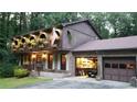 Two-story house with a brick garage and landscaping at 4567 Town Crier Sw Rd, Lilburn, GA 30047
