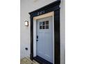 Stylish front door with black trim and updated light fixture at 2371 Wingfoot Pl, Decatur, GA 30035