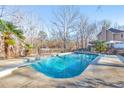 Inviting swimming pool with surrounding patio and trees at 98 Due West Ct, Dallas, GA 30157