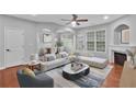 Bright living room featuring stylish furniture, fireplace and large windows at 593 Woodland Park Ter, Lawrenceville, GA 30043