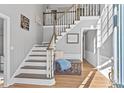 Bright entryway with wooden staircase and decorative accents at 695 Arboreal Ct, Alpharetta, GA 30022