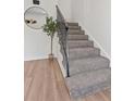 Modern staircase with simple metal railing and carpet at 4701 Flat Shoals Rd # 56E, Union City, GA 30291