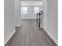 Bright foyer with gray wood-look floors and staircase at 3069 Shirecrest Lane, Dacula, GA 30019