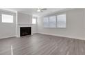 Spacious living room featuring a fireplace and gray vinyl plank flooring at 3069 Shirecrest Lane, Dacula, GA 30019