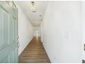 Bright entryway showcasing wood floors and a light fixture providing an inviting path through the home's neutral interior at 7268 Eton Ln, Locust Grove, GA 30248