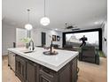 Island featuring a sink, quartz countertop, and wet bar, leading to an indoor movie simulator at 4927 Slaton Drive, Acworth, GA 30101