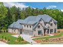Elegant two-story home featuring stone accents, a gray roof, and a well-maintained front yard at 4927 Slaton Drive, Acworth, GA 30101