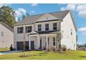 Charming two-story brick home featuring an attached two-car garage and a well-manicured front lawn at 5391 Heron Bay Blvd, Locust Grove, GA 30248