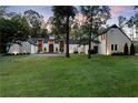 Stately two-story home showcasing its manicured lawn, mature trees, and classic architecture at 9650 Coleman Rd, Roswell, GA 30075