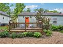 Relaxing backyard featuring a wood deck with chairs, string lights, and attractive gravel at 67 Holly Nw Rd, Atlanta, GA 30314