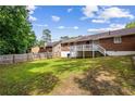 A well-maintained backyard with a wooden fence and an elevated deck at 2382 Old Rex Morrow Rd, Ellenwood, GA 30294