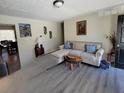 Living room with L-shaped sofa and wood-look floors at 2382 Old Rex Morrow Rd, Ellenwood, GA 30294