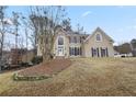 Two-story house with stone accents, shutters, and a landscaped yard at 610 Ashwood Ct, Woodstock, GA 30189