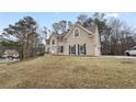 Two-story house with a stone facade, landscaped yard, and attached garage at 610 Ashwood Ct, Woodstock, GA 30189