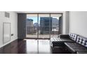 Comfortable living space with a large window offering a view of the city skyline at 620 Peachtree Ne St # 1206, Atlanta, GA 30308